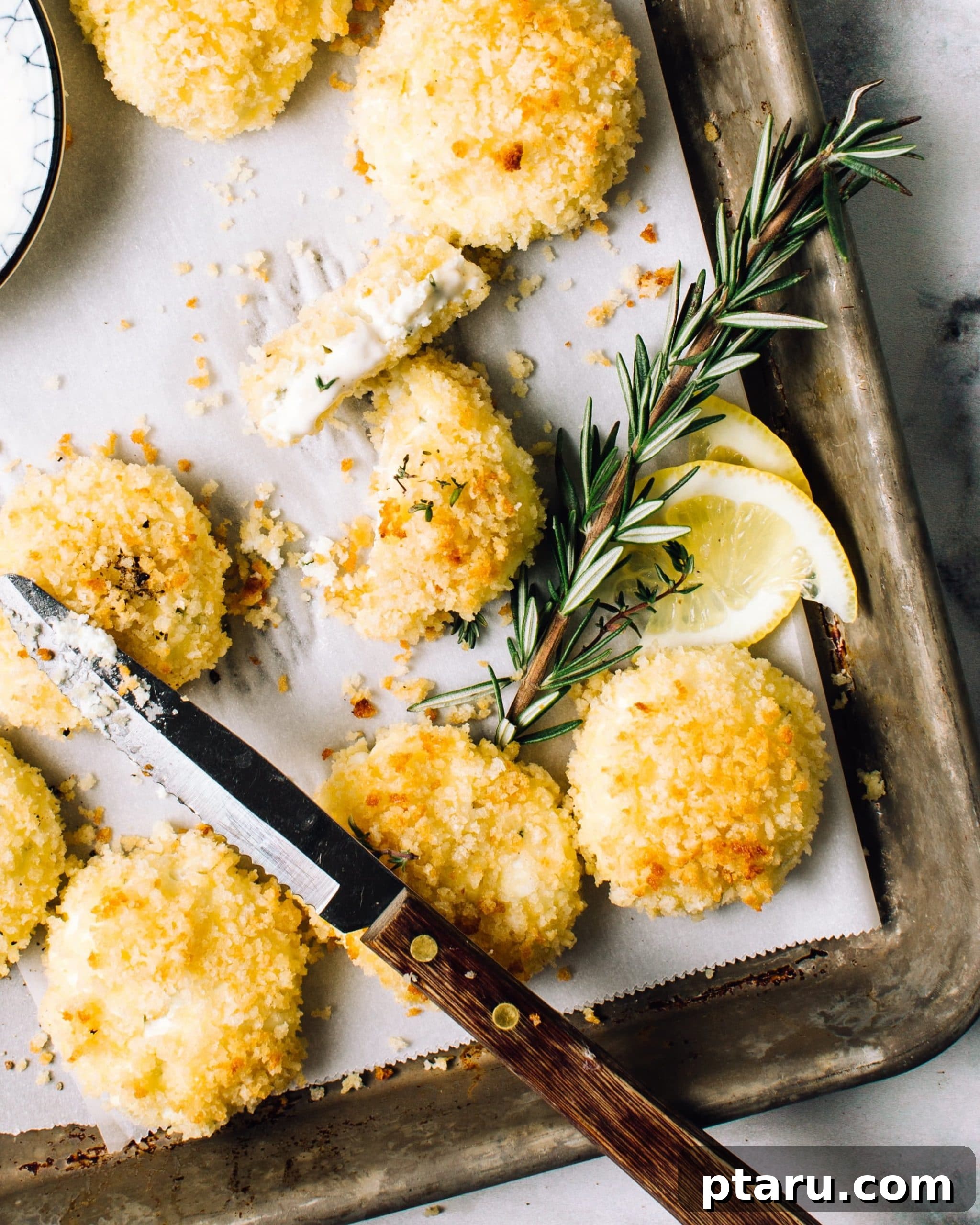 Herbed baked goat cheese fritters on a serving platter.