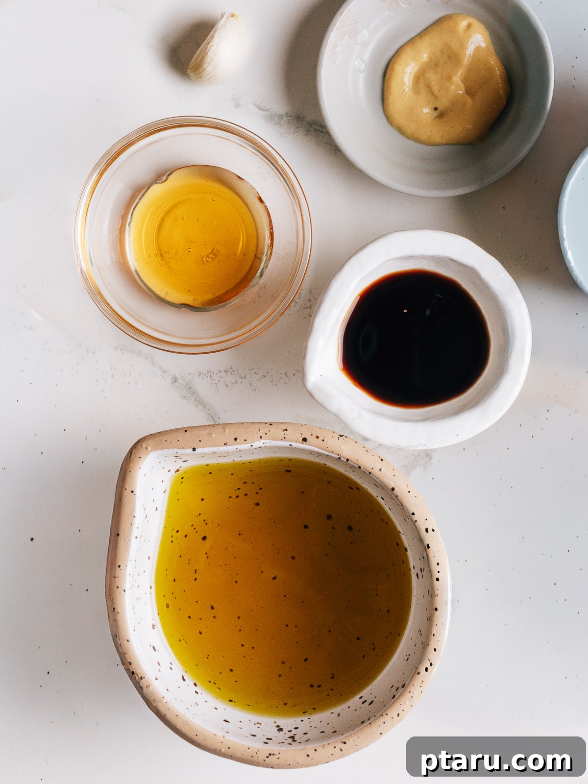 Homemade Balsamic Vinaigrette Recipe 3 Ingredients for balsamic vinaigrette on a counter.