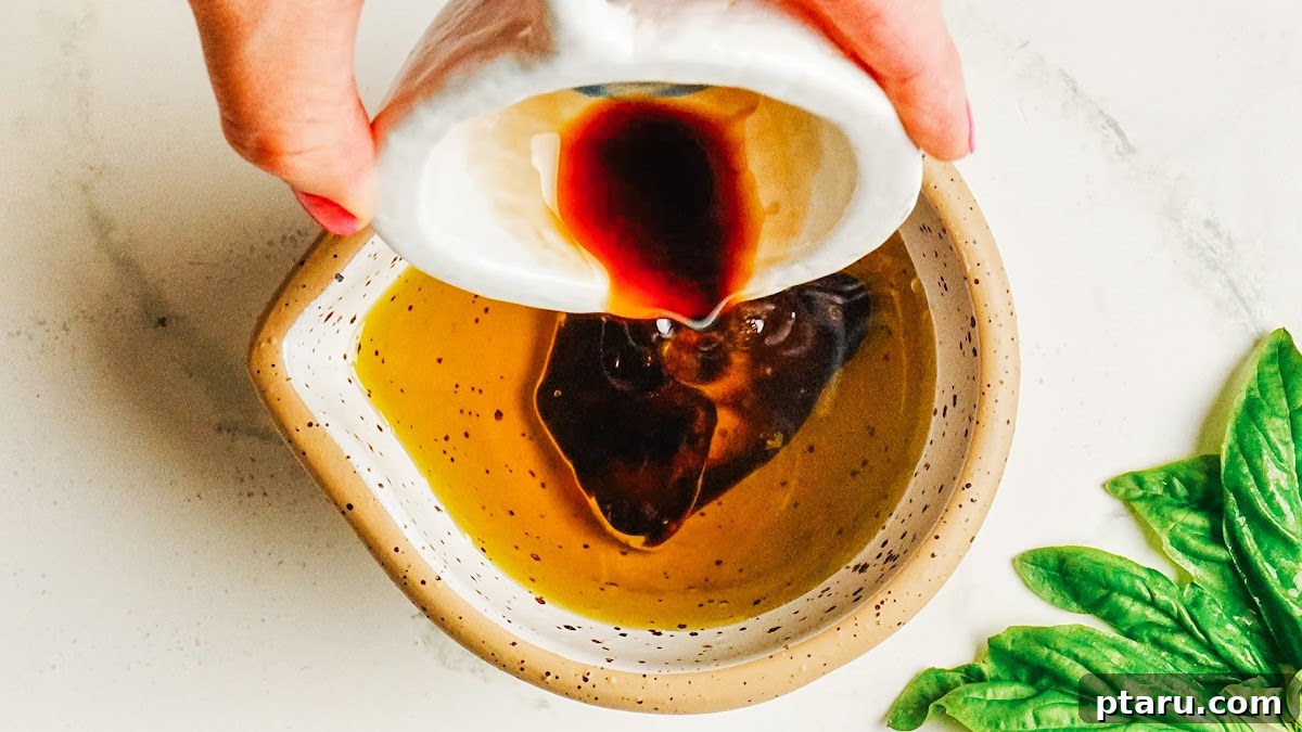 Homemade Balsamic Vinaigrette Recipe 4 Pouring balsamic vinegar into olive oil to start the vinaigrette.