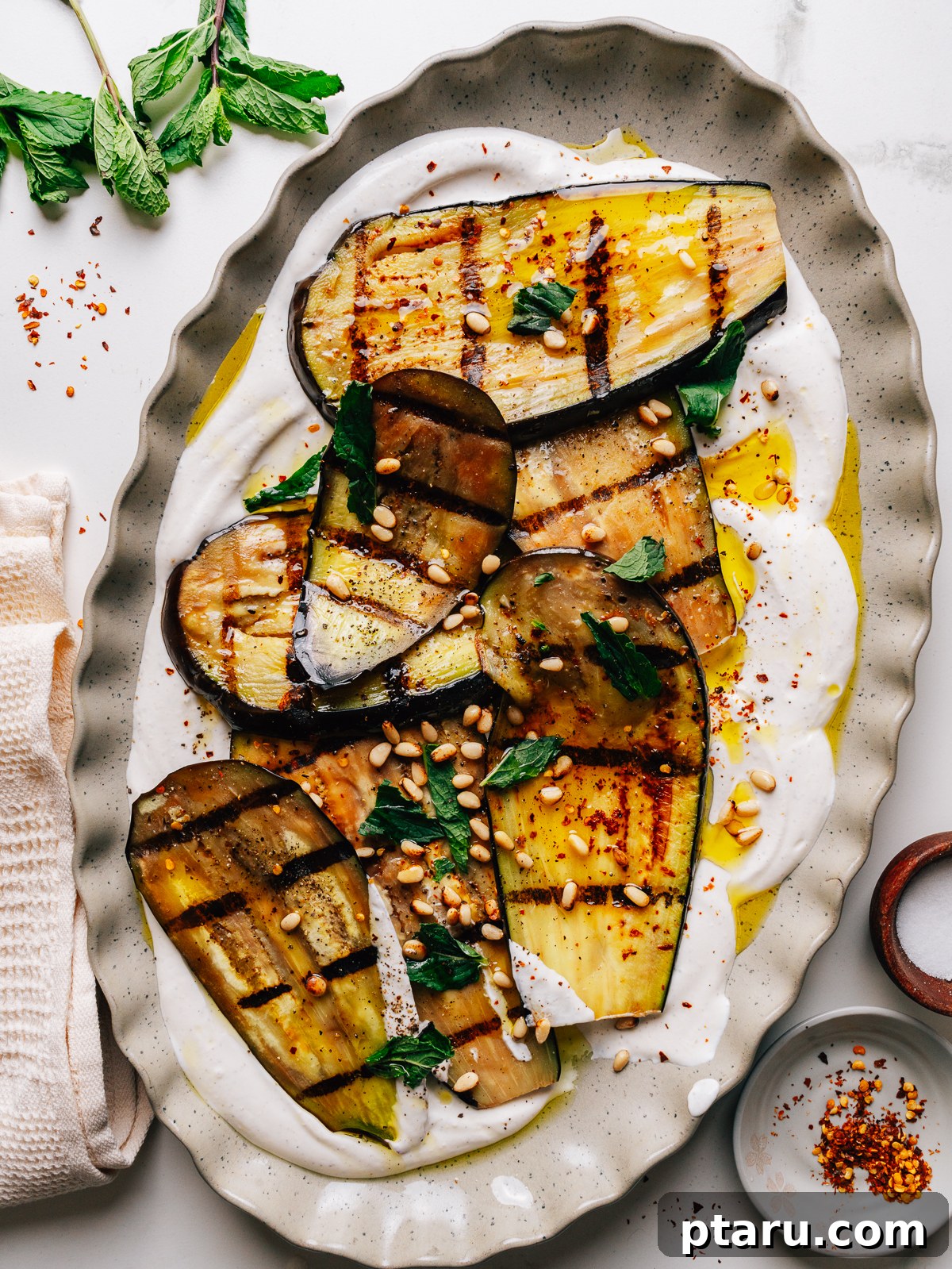 22 Summer Grilling Recipes Everyone Will Love 21 Grilled eggplant strips arranged over whipped feta with mint and pine nuts on a platter.