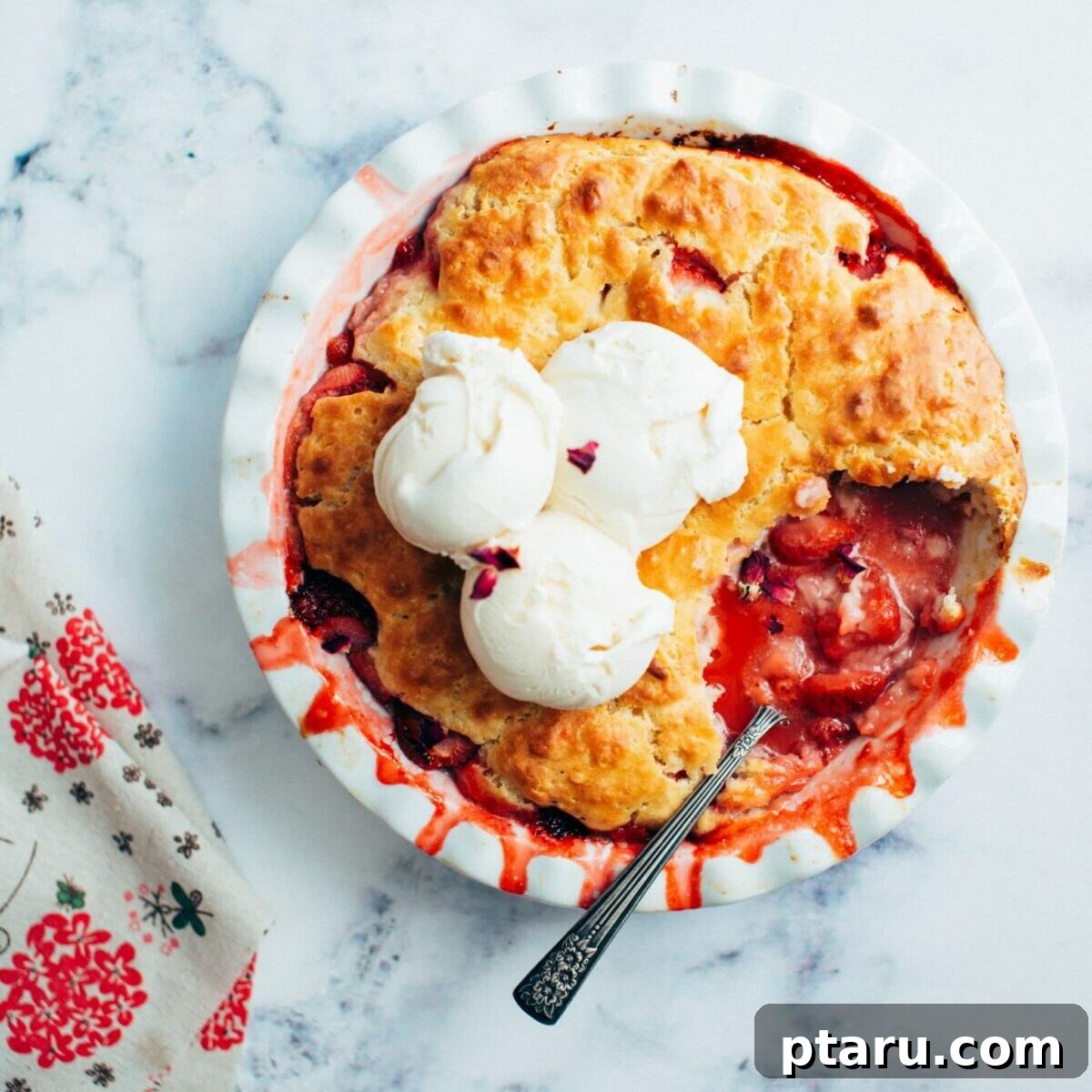 Strawberry cobbler with golden biscuit topping.
