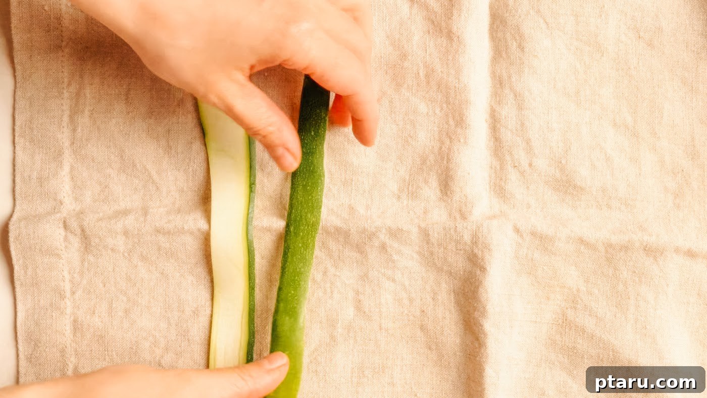 Zucchini Ribbon Salad with Lemon-Parmesan Vinaigrette 7 Blotting shaved zucchini ribbons dry on a tea towel.