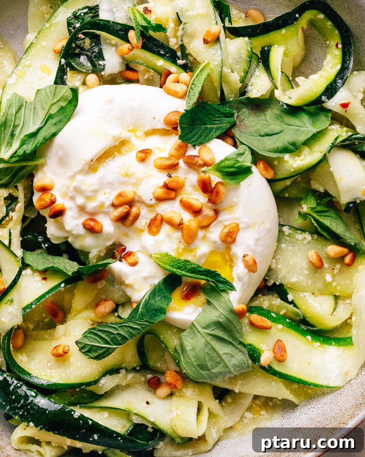 Zucchini Ribbon Salad with Lemon-Parmesan Vinaigrette 9 Zucchini salad with creamy burrata, toasted pine nuts, and fresh herbs in a bowl.