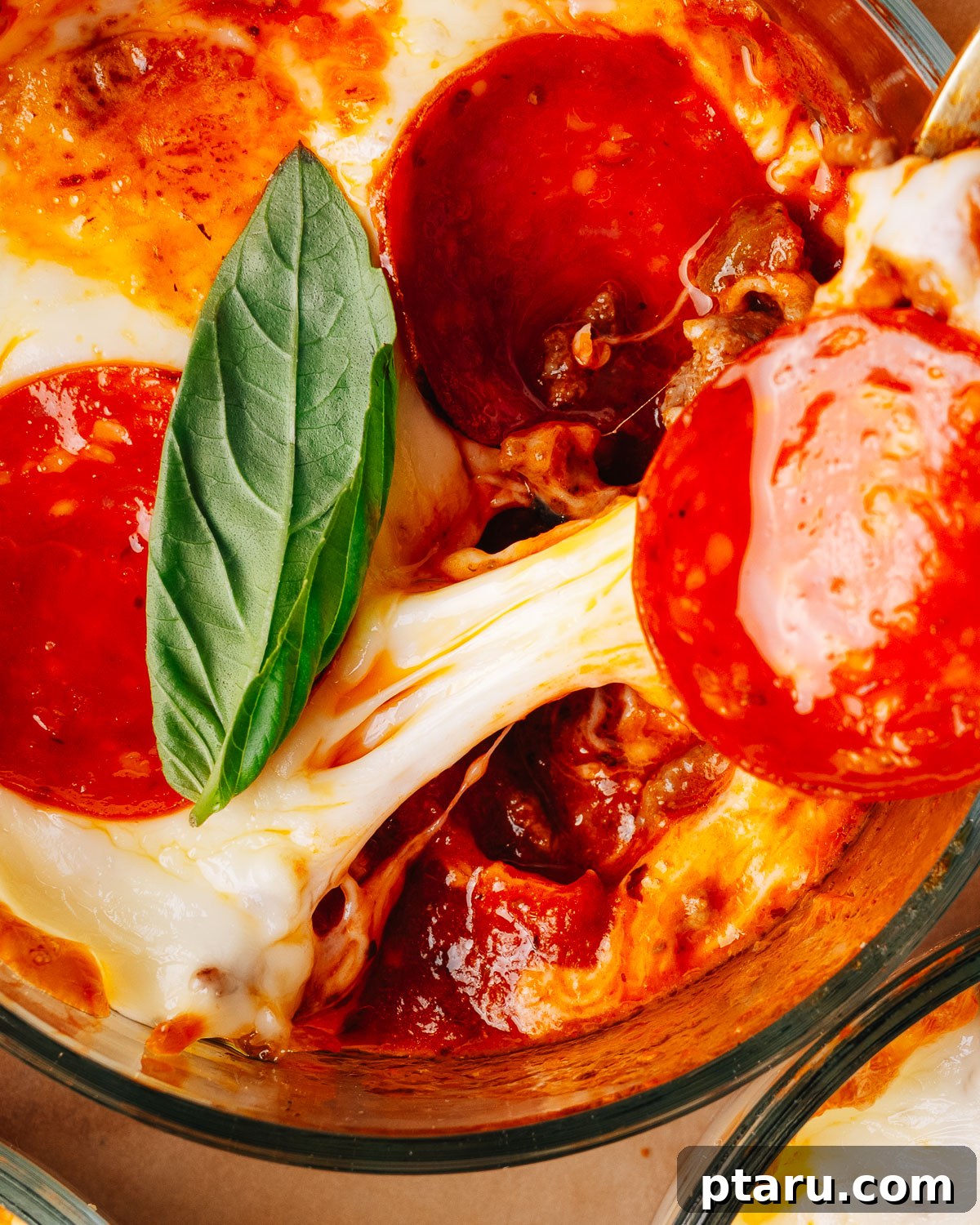 Loaded Cheesy Pizza Bowl Recipe 11 Pepperoni pizza bowls topped with fresh basil on a sheet pan.