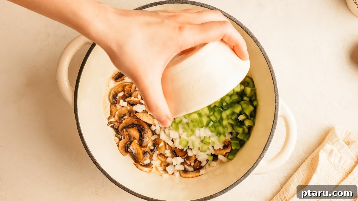 Loaded Cheesy Pizza Bowl Recipe 5 Step 2: mushrooms, onion, and green pepper cooking together in a pot.