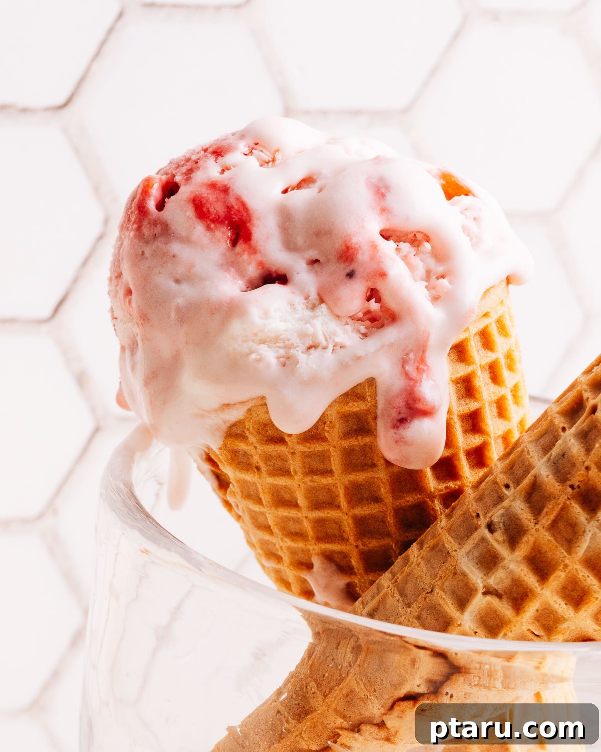 Scoop of homemade strawberry ice cream in a cone.