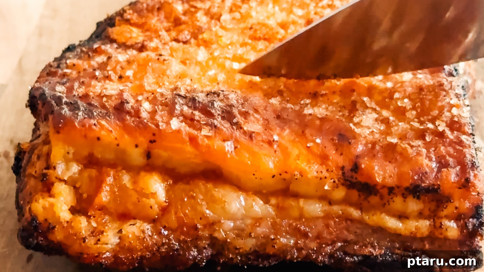 Slow-Roasted Pork Belly with Crispy Crackling 3 Sliced crispy pork belly showing layers of tender meat and blistered crackling.