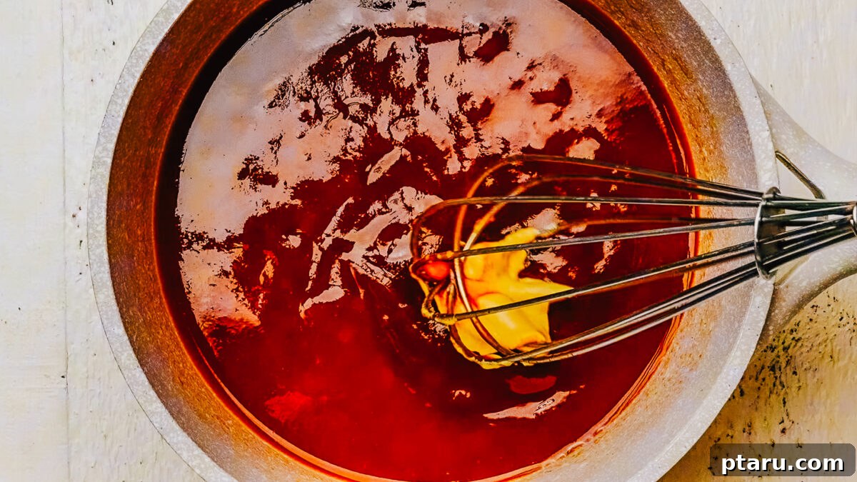 Homemade Honey BBQ Sauce Recipe 5 Whisking Dijon mustard into the honey BBQ sauce in a saucepan.