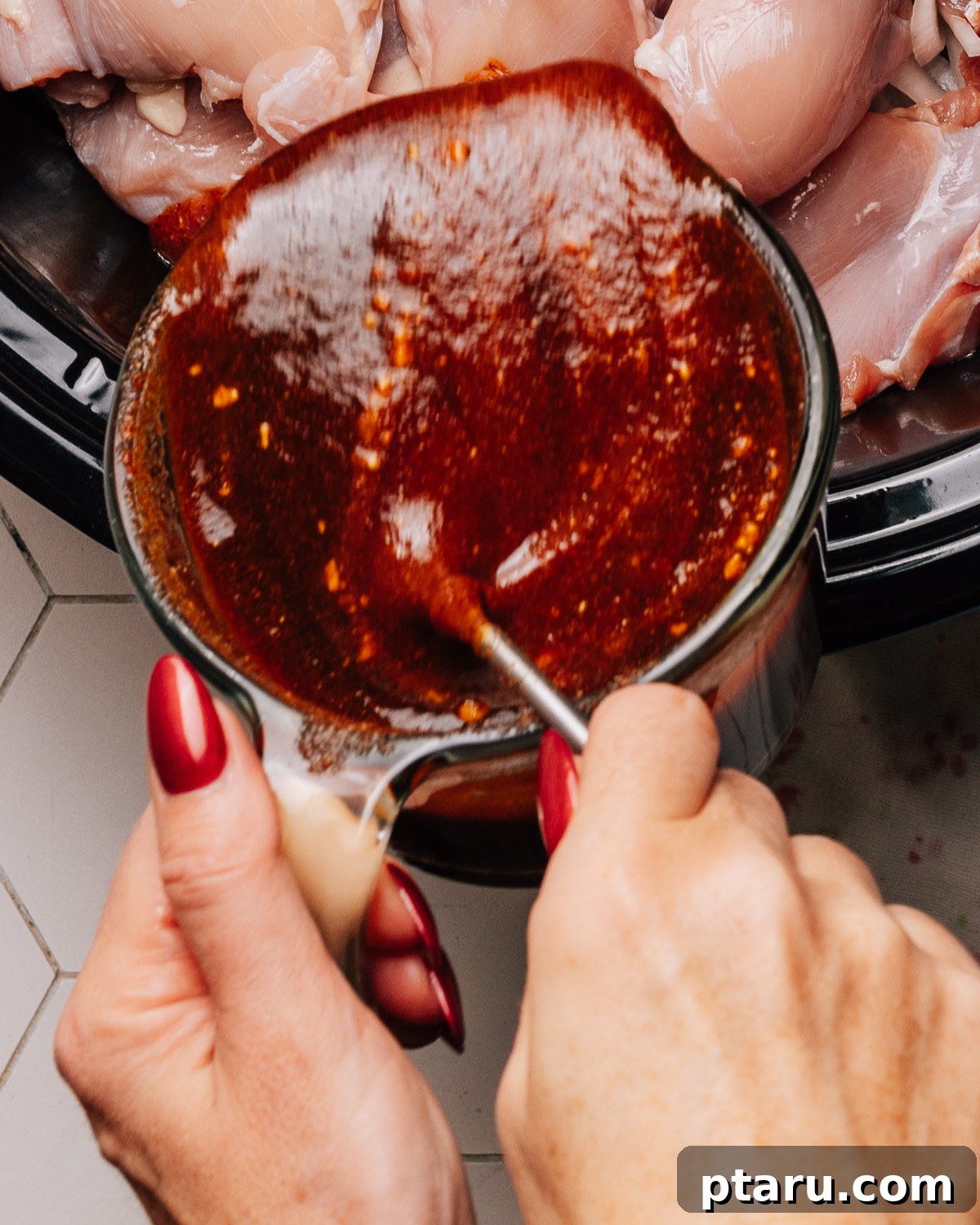 Homemade Honey BBQ Sauce Recipe 7 Pouring Sweet Honey BBQ sauce over chicken thighs.