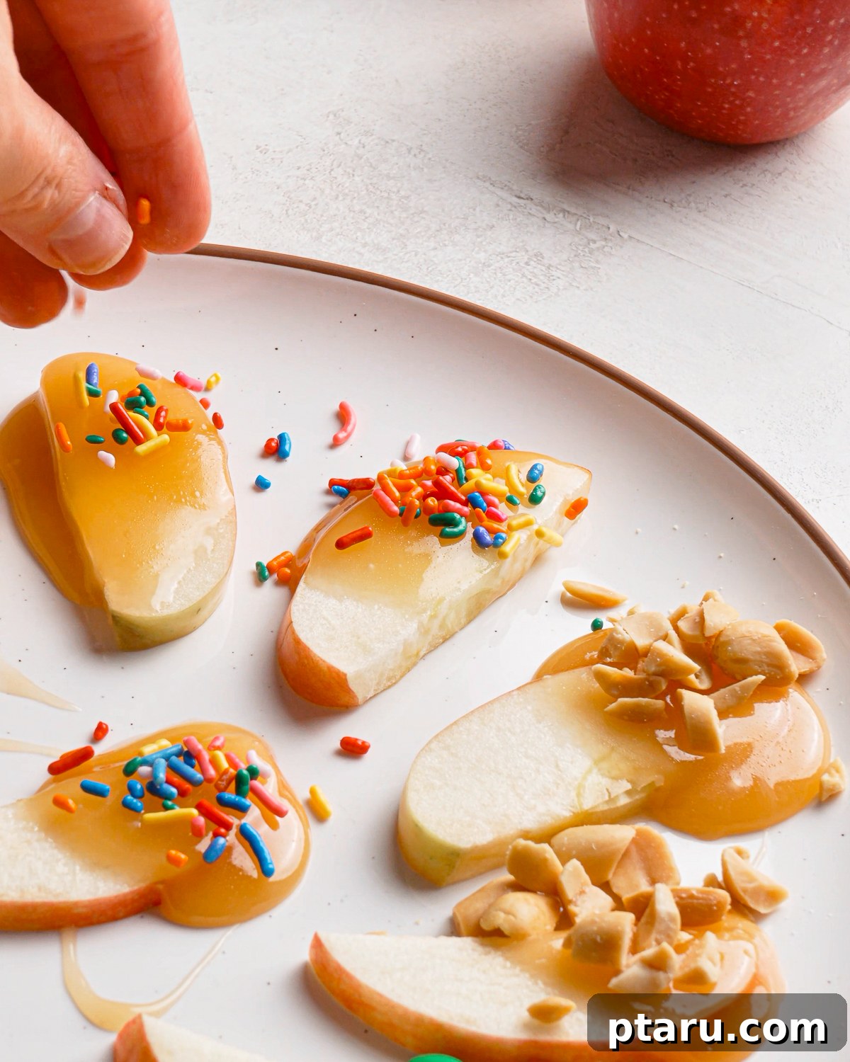 Caramel Apple Slices with Homemade Caramel Sauce 11 Adding sprinkles to caramel apple slices before the caramel sets.