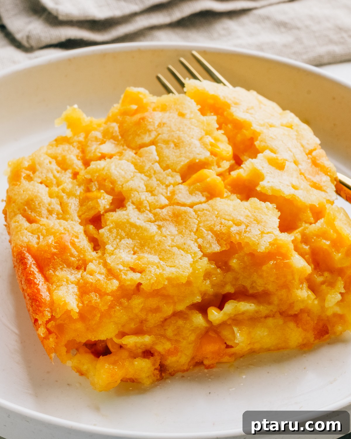 Creamy Jiffy Corn Casserole Recipe: Soft & Comforting 2 Baked corn casserole in a white dish