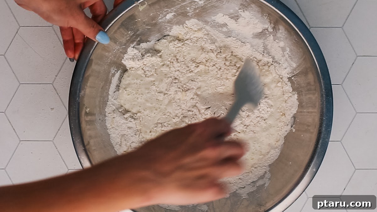 Soft Pumpkin Scones Recipe with Cinnamon Glaze 4 Stirring the biscuit topping for easy peach cobbler.