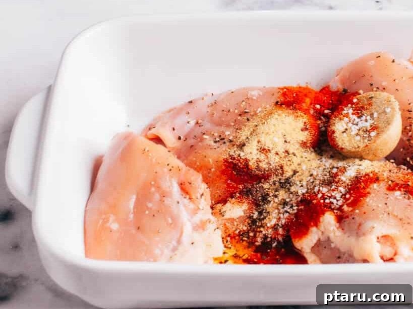 All-Purpose Chicken Seasoning I Use on Everything 5 Homemade chicken seasoning on raw chicken thighs in a baking dish.
