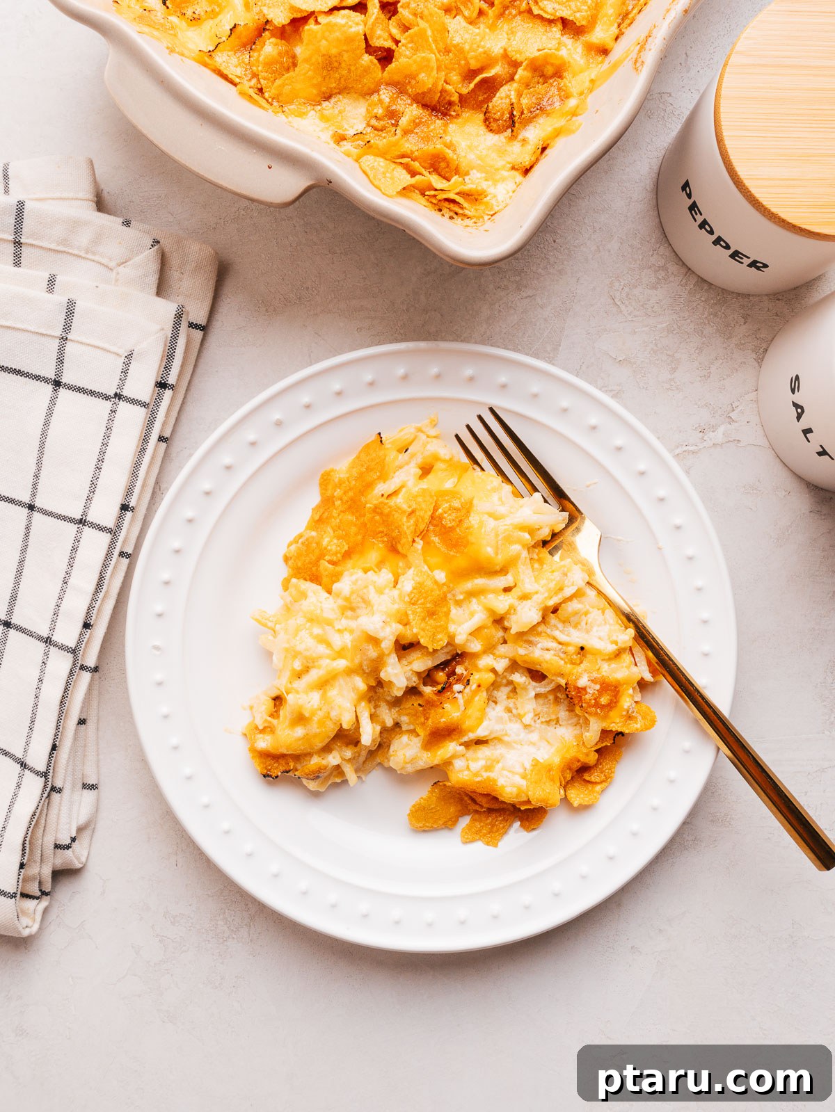 Funeral Potatoes: Cheesy Casserole with Cornflake Topping 13 Funeral potatoes with a buttered cornflake topping.