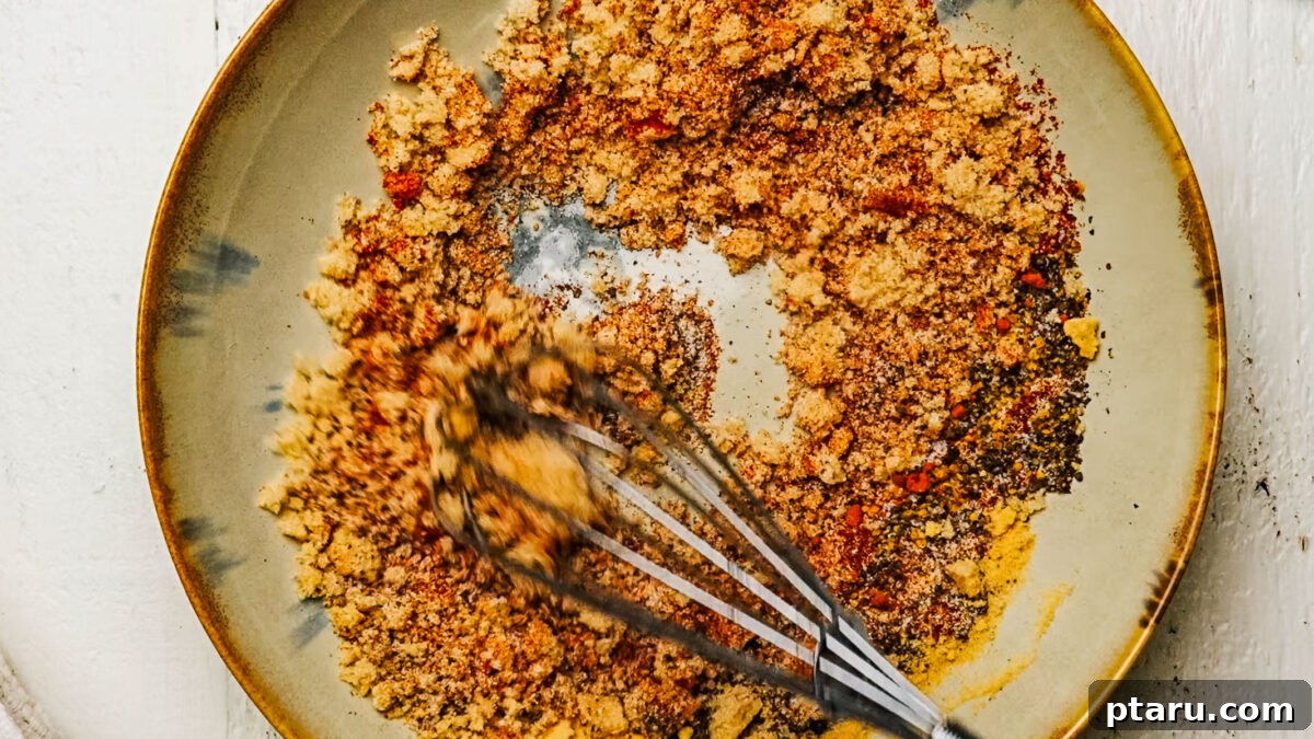 Sweet Dry Rub for Ribs: Flavorful BBQ Seasoning 3 Sweet rib rub mixed in a bowl beside two racks of ribs.