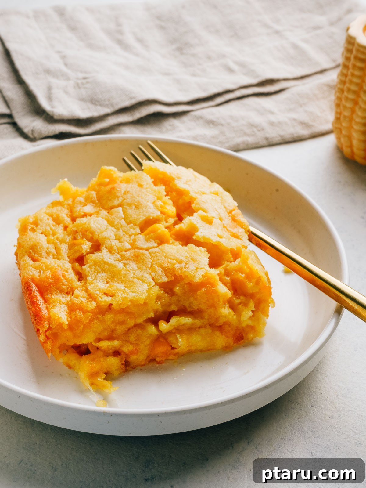 30 Make-Ahead Thanksgiving Side Dishes Your Guests Will Love 11 Jiffy corn casserole served on a plate.
