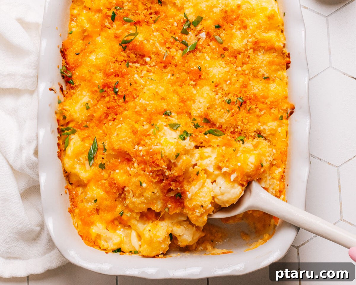 30 Make-Ahead Thanksgiving Side Dishes Your Guests Will Love 12 A cheesy cauliflower casserole browned on top in an oval baking dish.