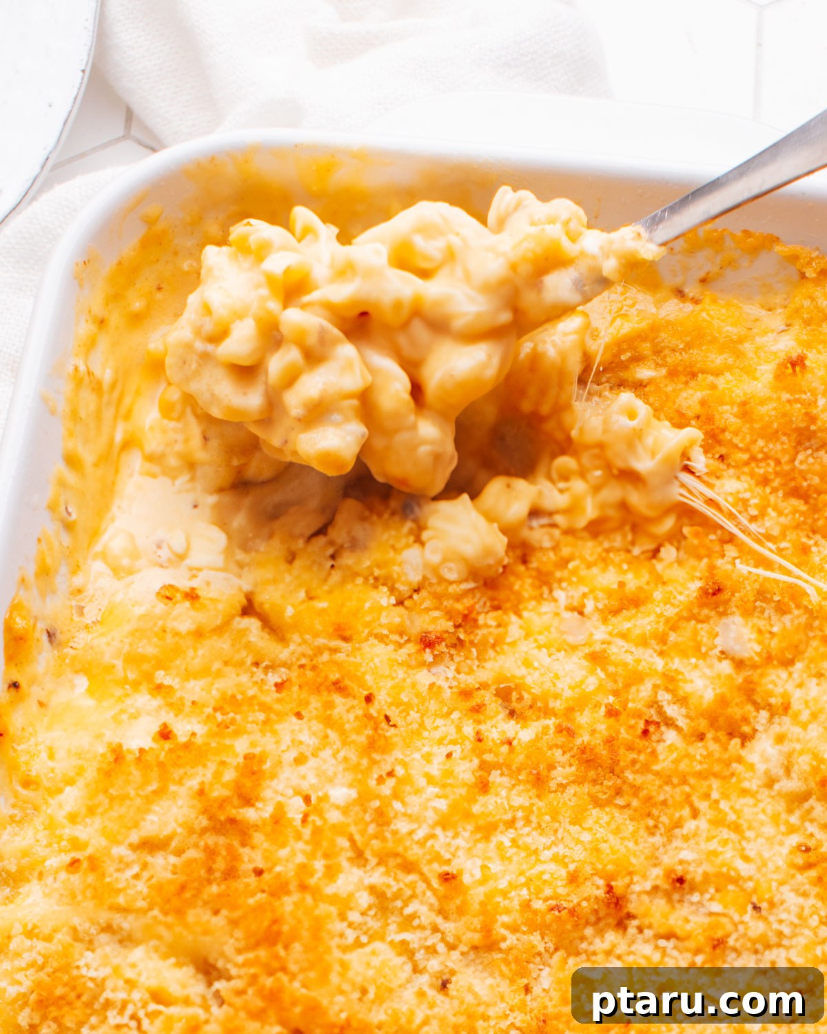 30 Make-Ahead Thanksgiving Side Dishes Your Guests Will Love 13 Baked macaroni and cheese with a deeply browned crust being served.