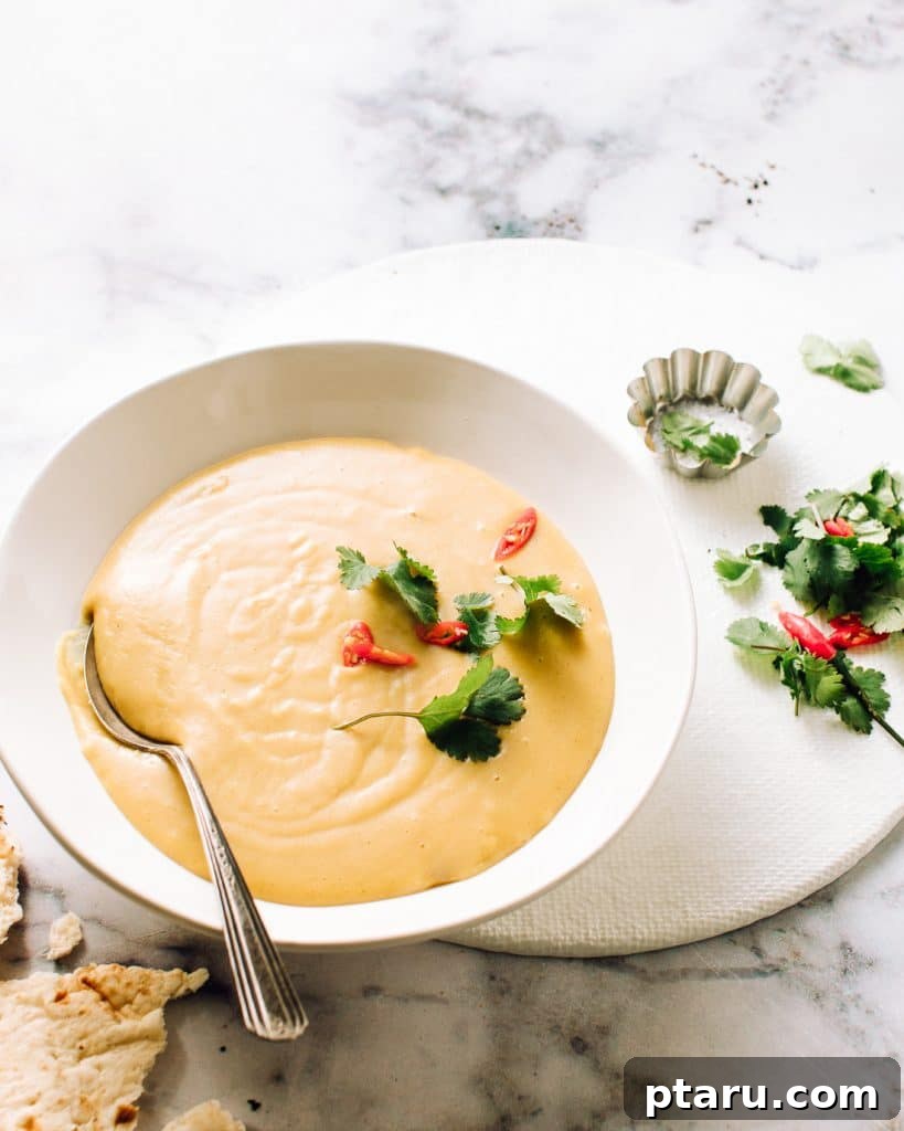 30 Make-Ahead Thanksgiving Side Dishes Your Guests Will Love 28 Golden coconut squash soup in a bowl with a drizzle of coconut milk.