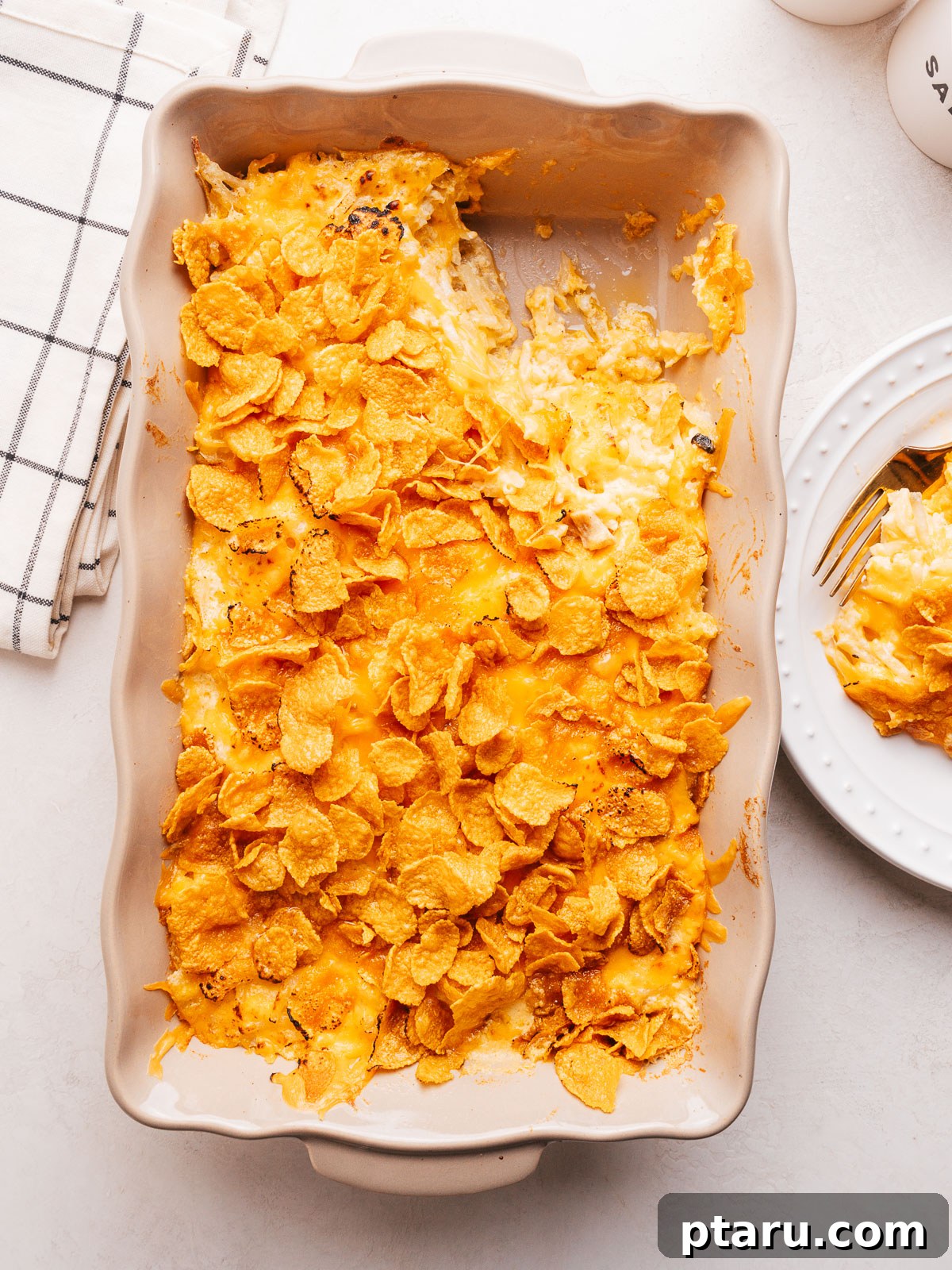 30 Make-Ahead Thanksgiving Side Dishes Your Guests Will Love 10 Cheesy potato casserole with a golden cornflake topping in a baking dish.