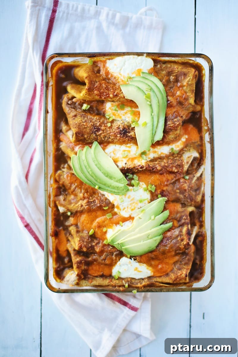 17 Comforting Butternut Squash Recipes for Fall Dinners 17 Spicy pumpkin black bean enchiladas baked in a dish under melted cheese.