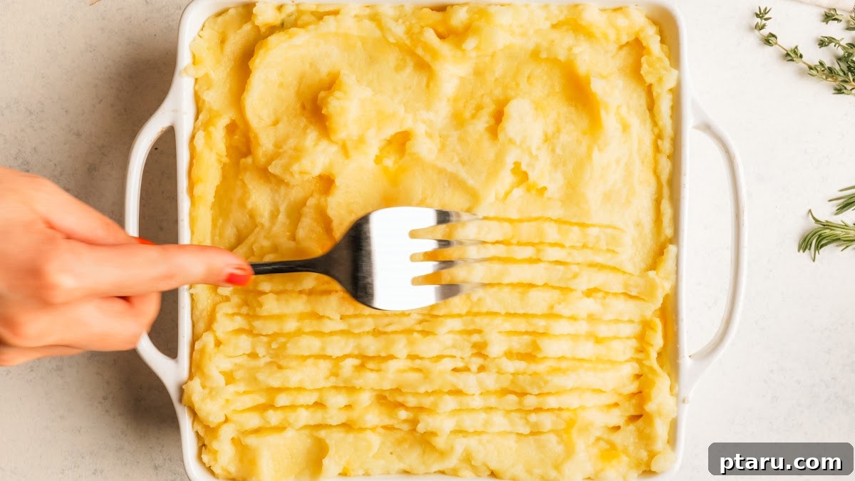 Classic Shepherd's Pie with Ground Beef or Lamb 12 Raking the mashed potato topping with a fork before baking.