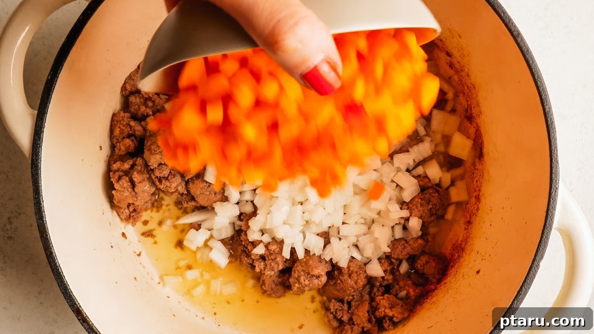 Classic Shepherd's Pie with Ground Beef or Lamb 7 Adding diced onion, carrots and celery to the browned meat.