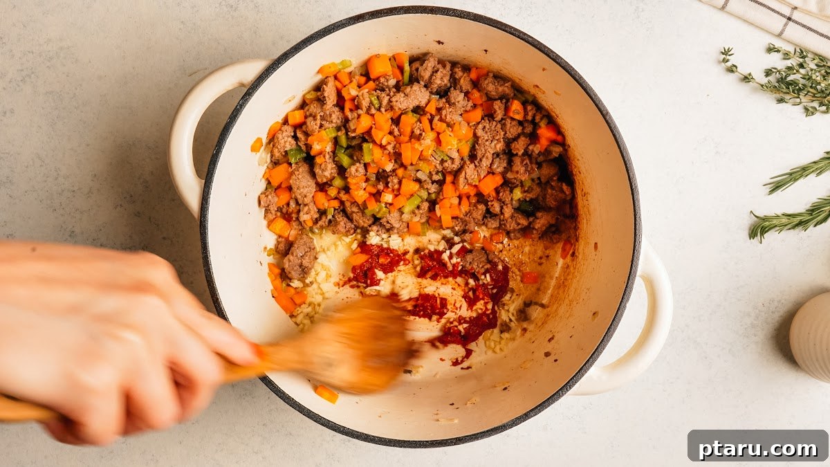 Classic Shepherd's Pie with Ground Beef or Lamb 8 Darkening the tomato paste beside the browned meat.