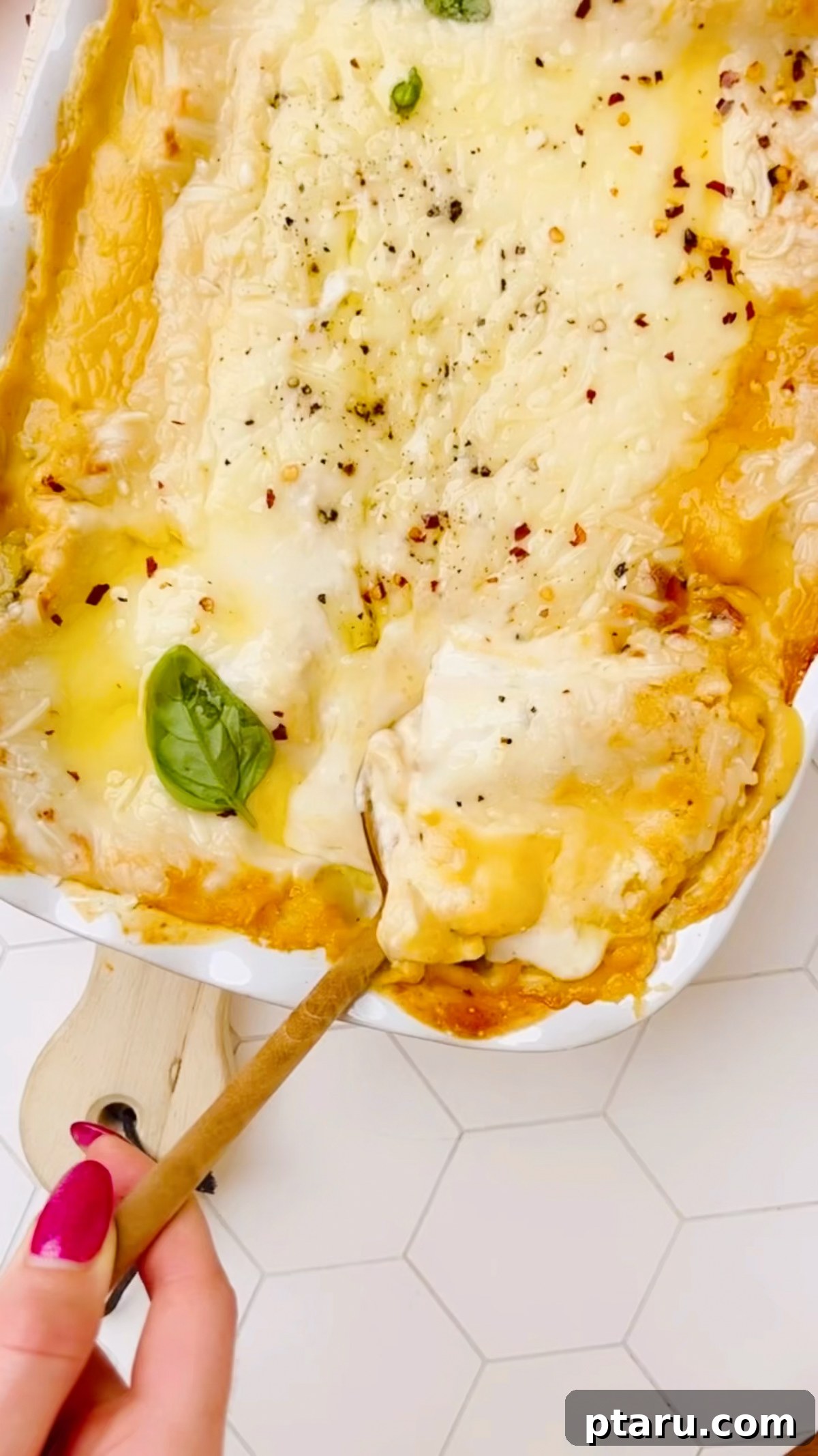 Butternut Squash Lasagna with Creamy Béchamel 16 A slice of butternut squash lasagna lifted out of the baking dish.