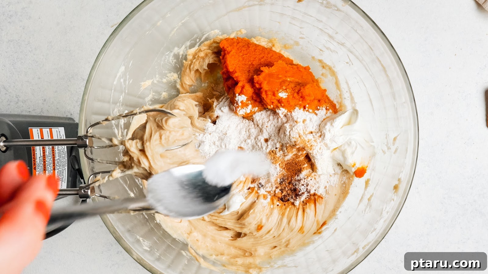 Silky Pumpkin Cheesecake with Gingersnap Crust 8 Adding pumpkin, sour cream, flour and spices to the cream cheese mixture.