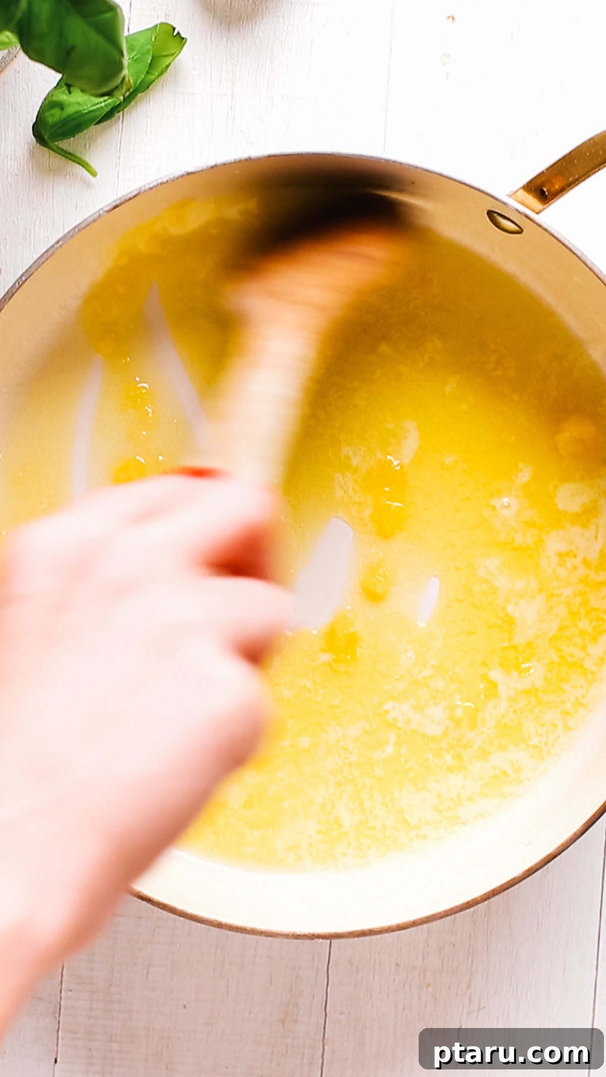 How to Make Garlic Cream Sauce 6 Stirring garlic into melted butter in a saucepan.